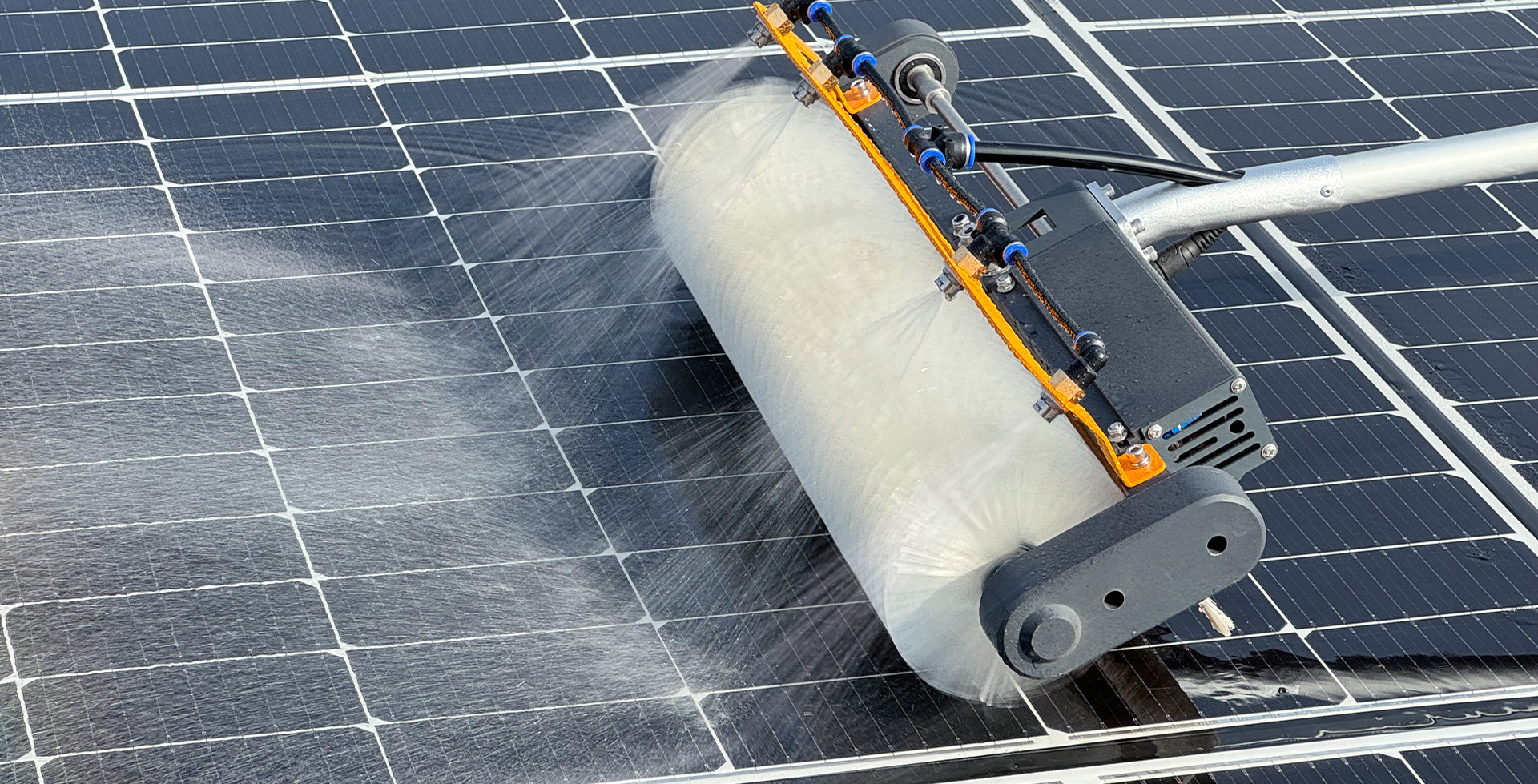 Large-scale solar farm installation being cleaned with professional equipment